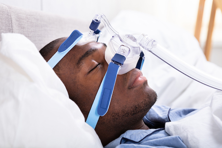 Man sleeping with CPAP mask on